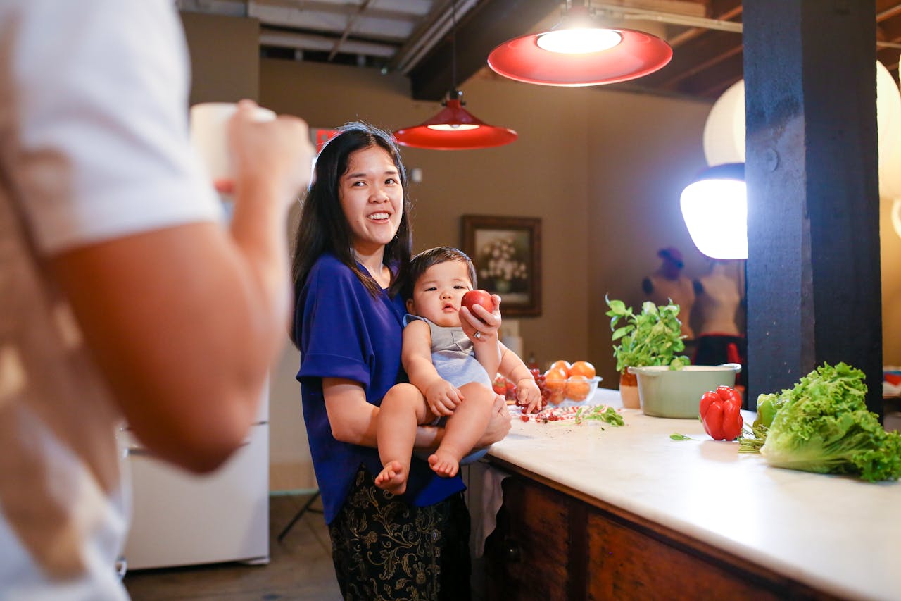 Young family enjoying quality cooking time together in a cozy indoor kitchen setting.